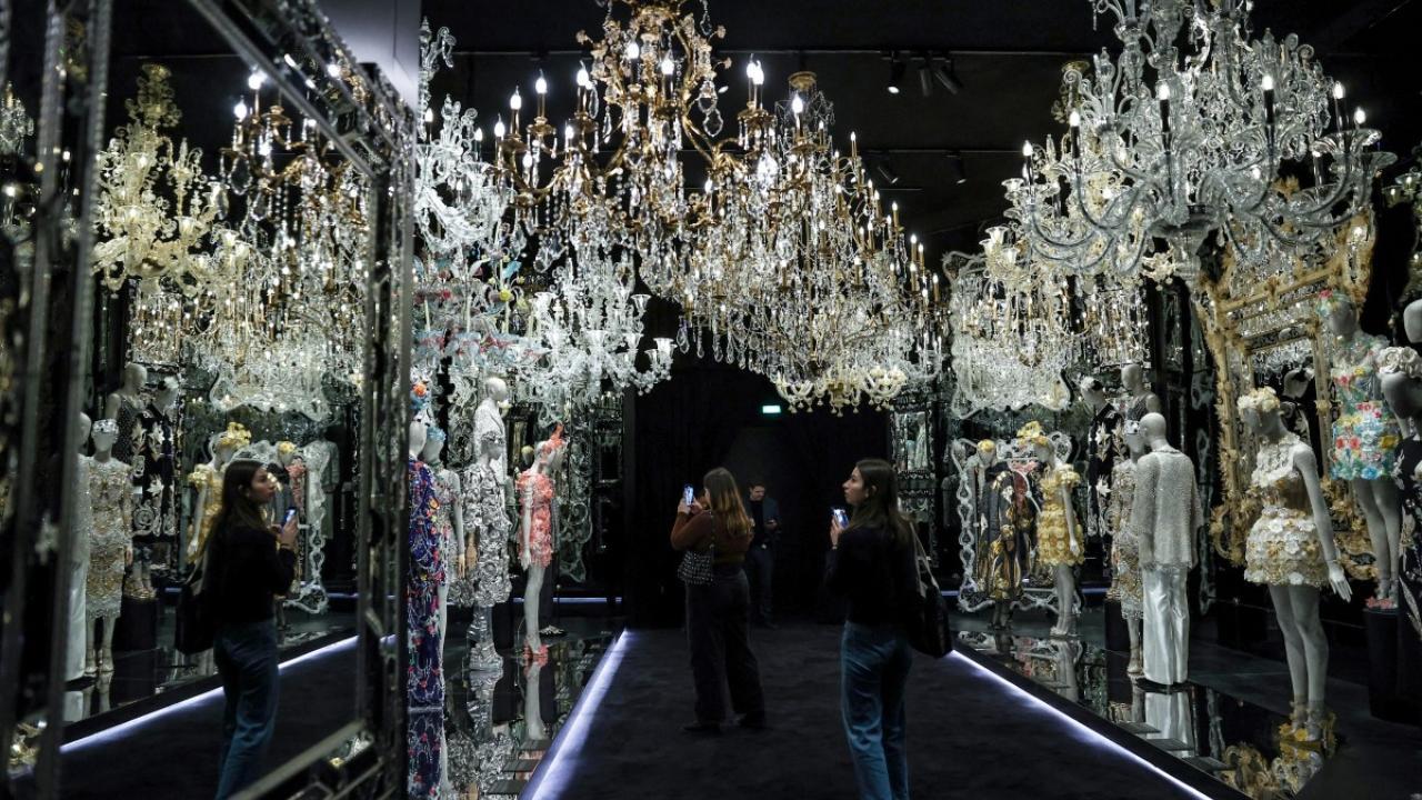 Visitors take pictures of creations of Italian luxury fashion house Dolce & Gabbana at the exhibition