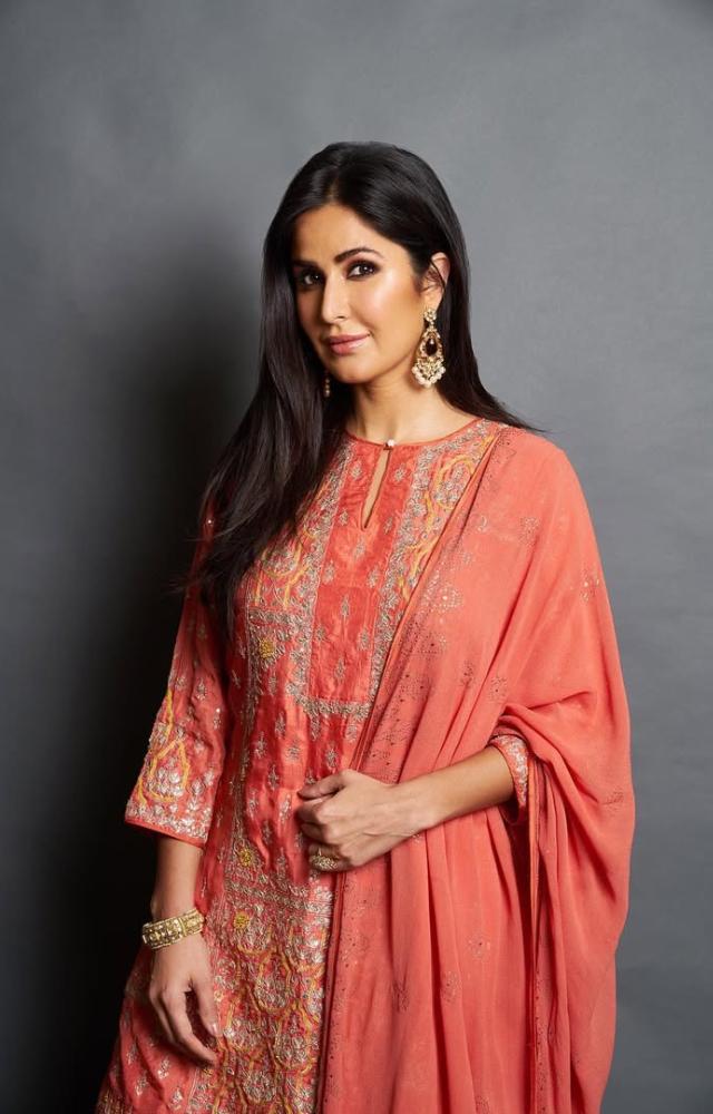 Don`t want to wear white? Choose an orange or green ensemble. Here, Katrina Kaif looks elegant in an orange outfit. 