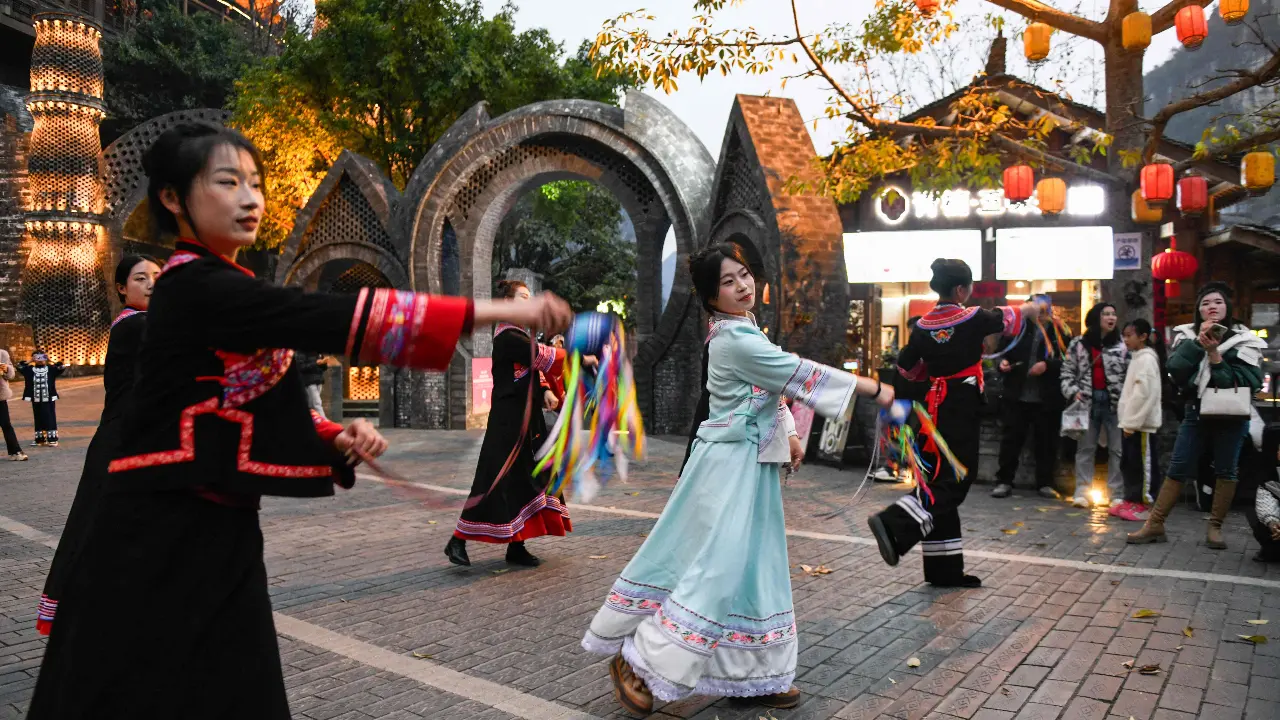 Folk performers dance at a festival in Xingyi, in China’s southwest Guizhou province ahead of the Lunar New Year