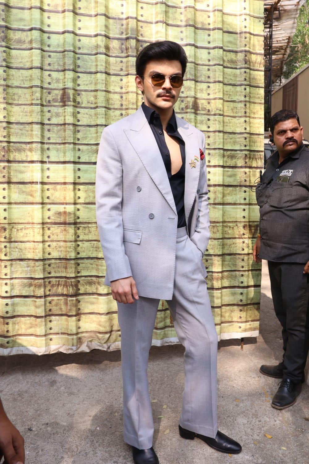 Veer Pahariya opted for a grey formal suit with a black shirt