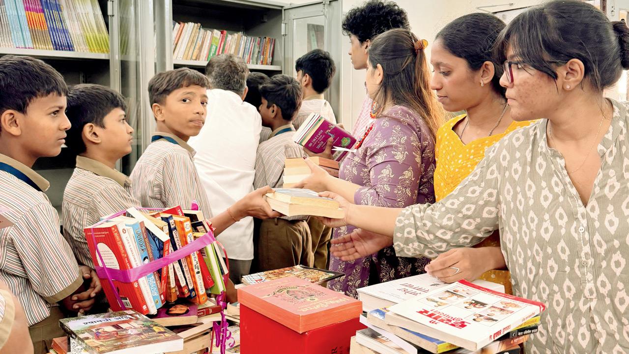 Students join volunteers in setting up a mini-library in Kurla