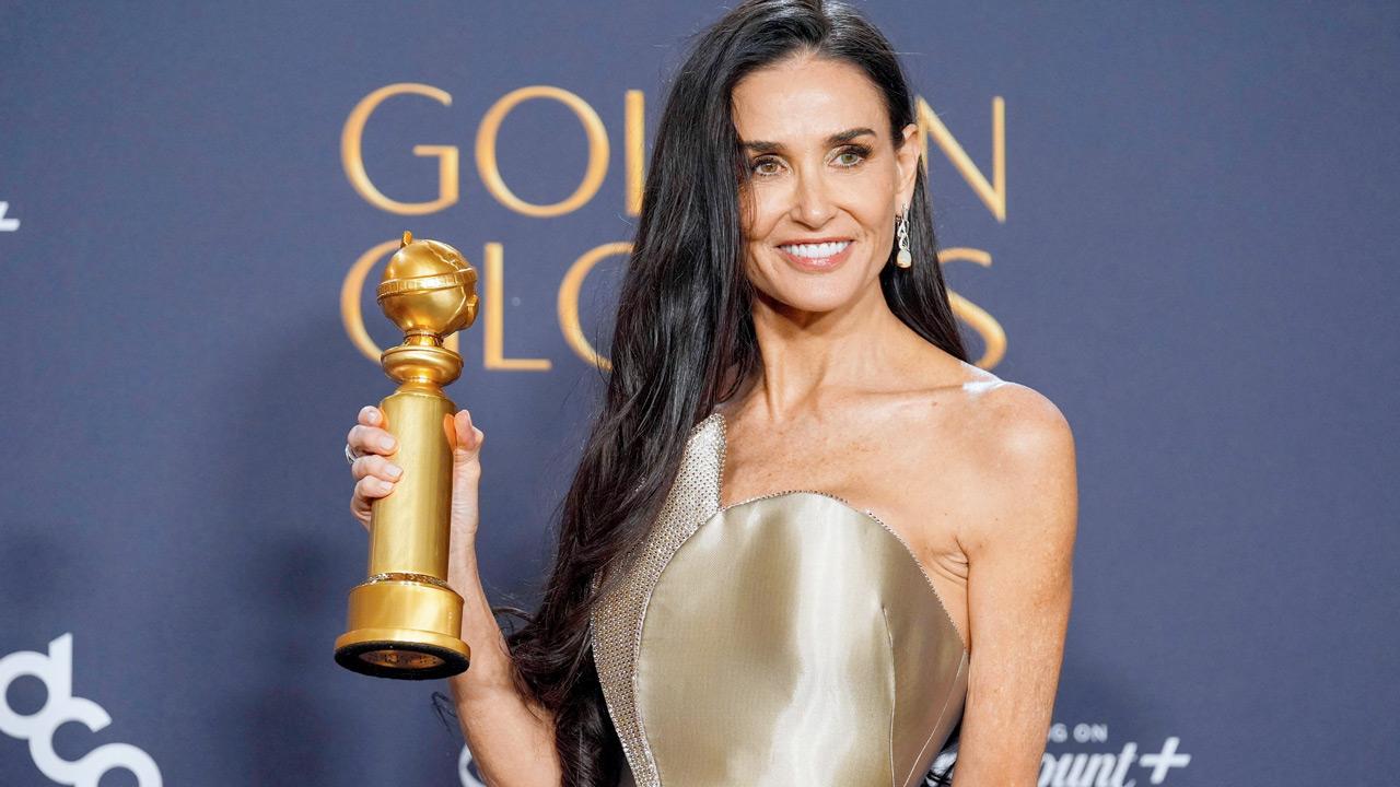 Demi Moore styles it up in satin and gold