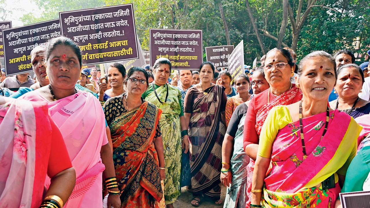 A contingent of female protestors raises banners against the survey