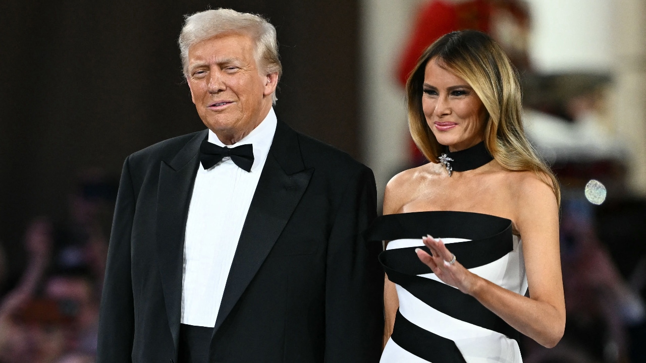 The first lady wore a white column gown featuring sculptural, serpentine black ribbon detailing with a thick black bejeweled choker to match as she attended the traditional series of inaugural balls.