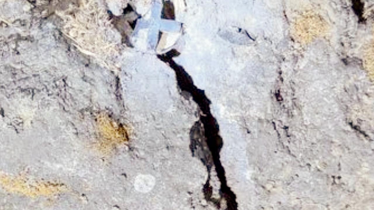 The damaged fastener stuck between rocks 