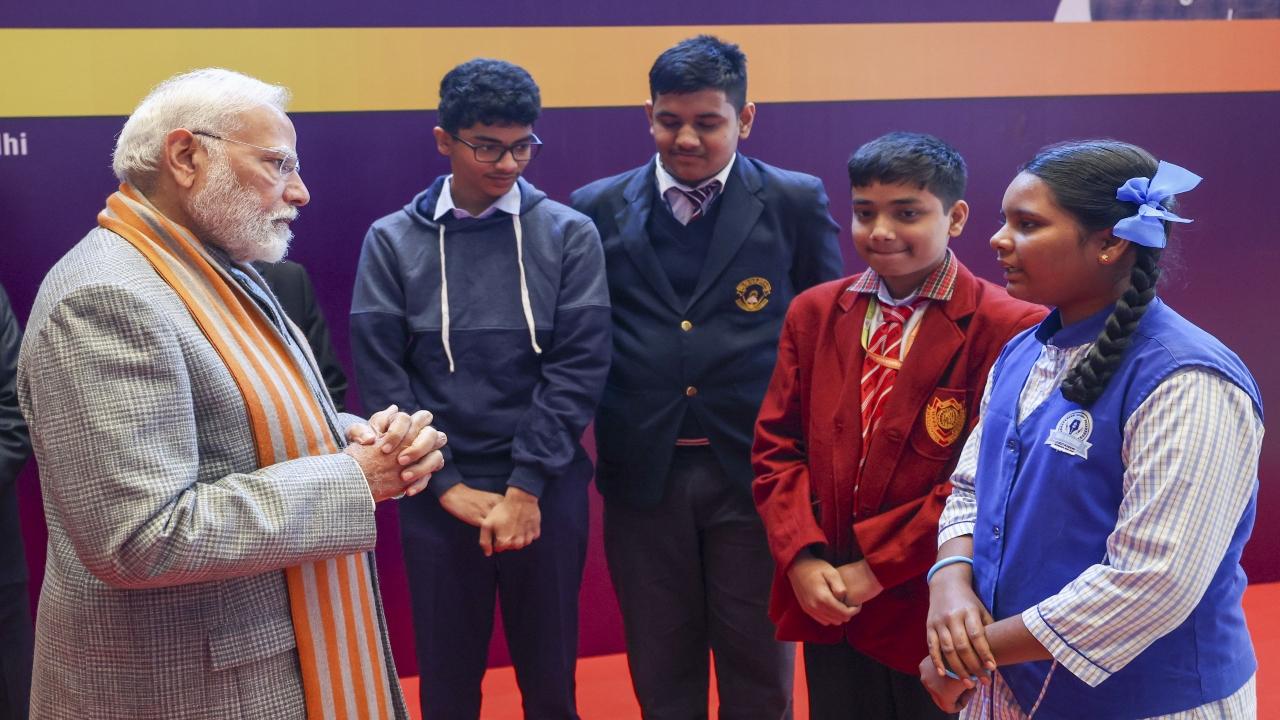 PM Modi interacts with students at an exhibition organised to mark the foundation day