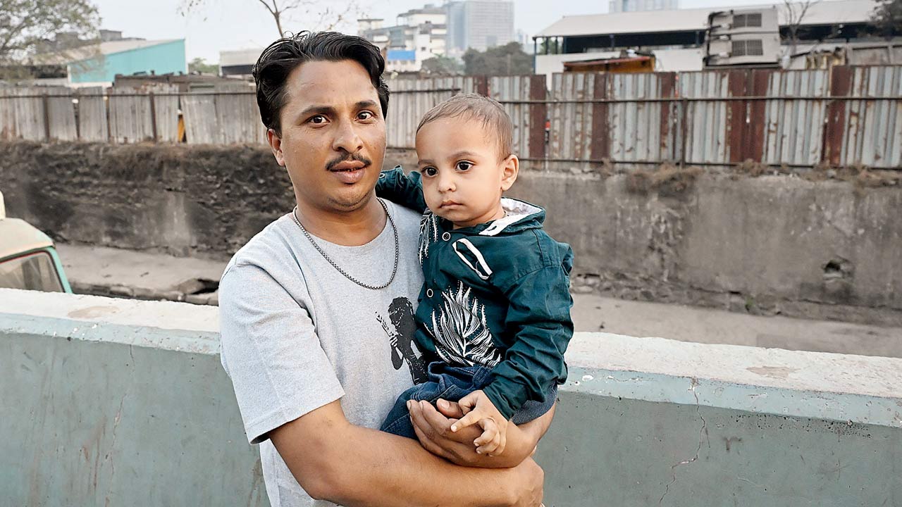 Mohammed Rafiq, a resident of the area, with his child
