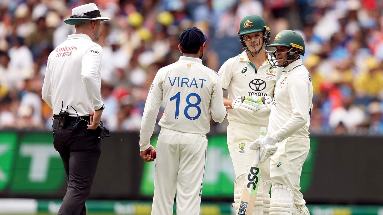 Virat Kohli chats with Sam Konstas (centre) at MCG
