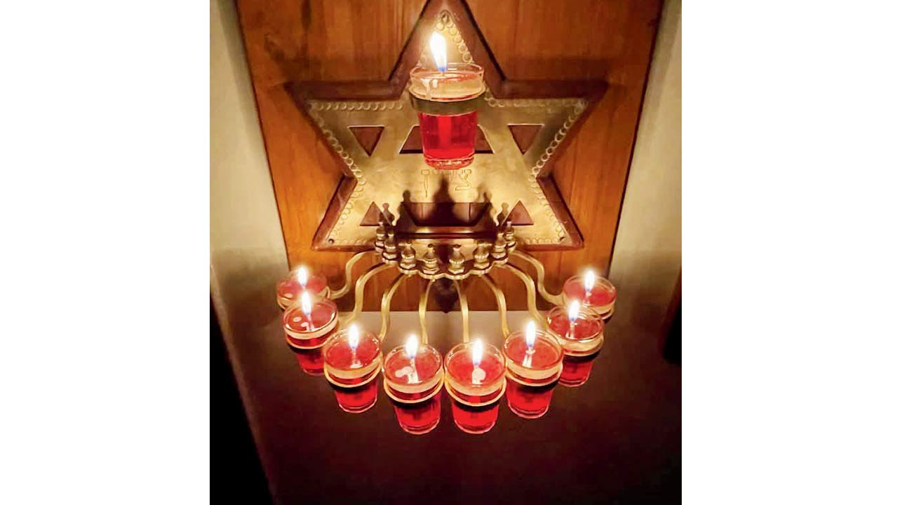 A menorah fitted with oil lamps instead of candles