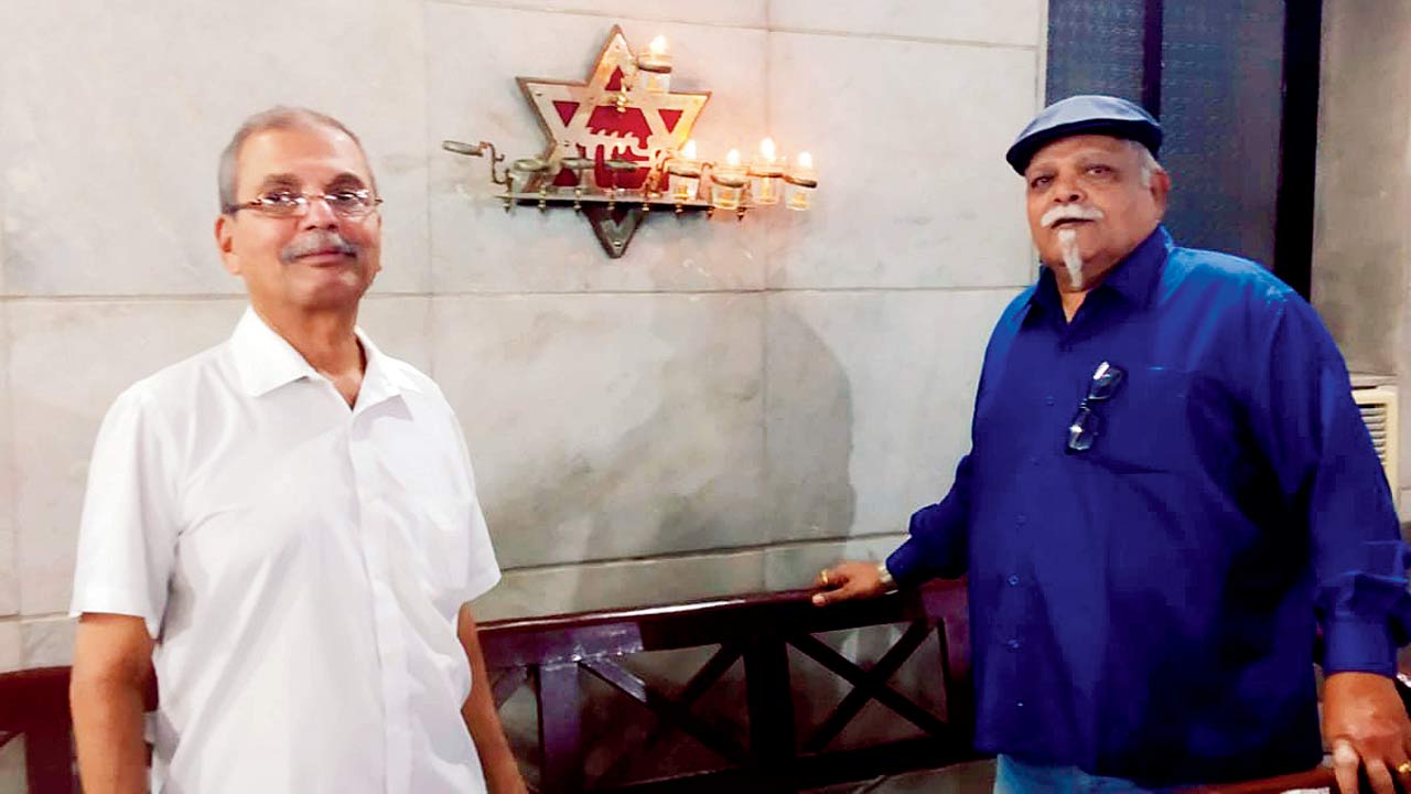 Traditional oil lamps glow in the Beth El synagogue at Panvel