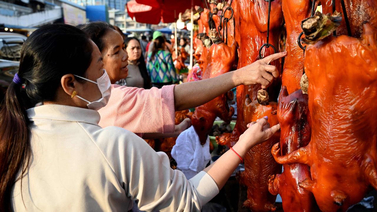 A customer looks at roasted pigs for sale at a market in preparation for the Lunar New Year celebrations in Phnom Penh in Cambodia on January 28