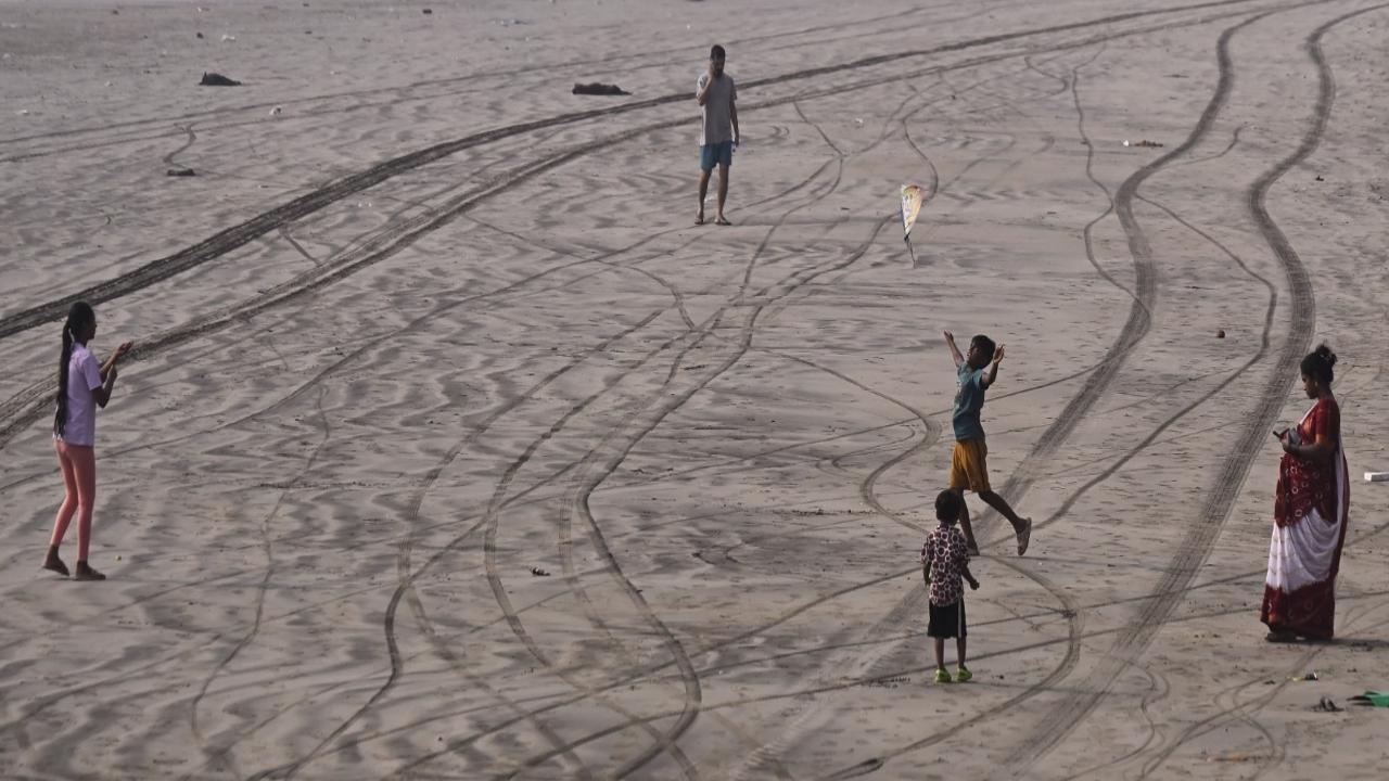 Kids fly their kites at Versova beach