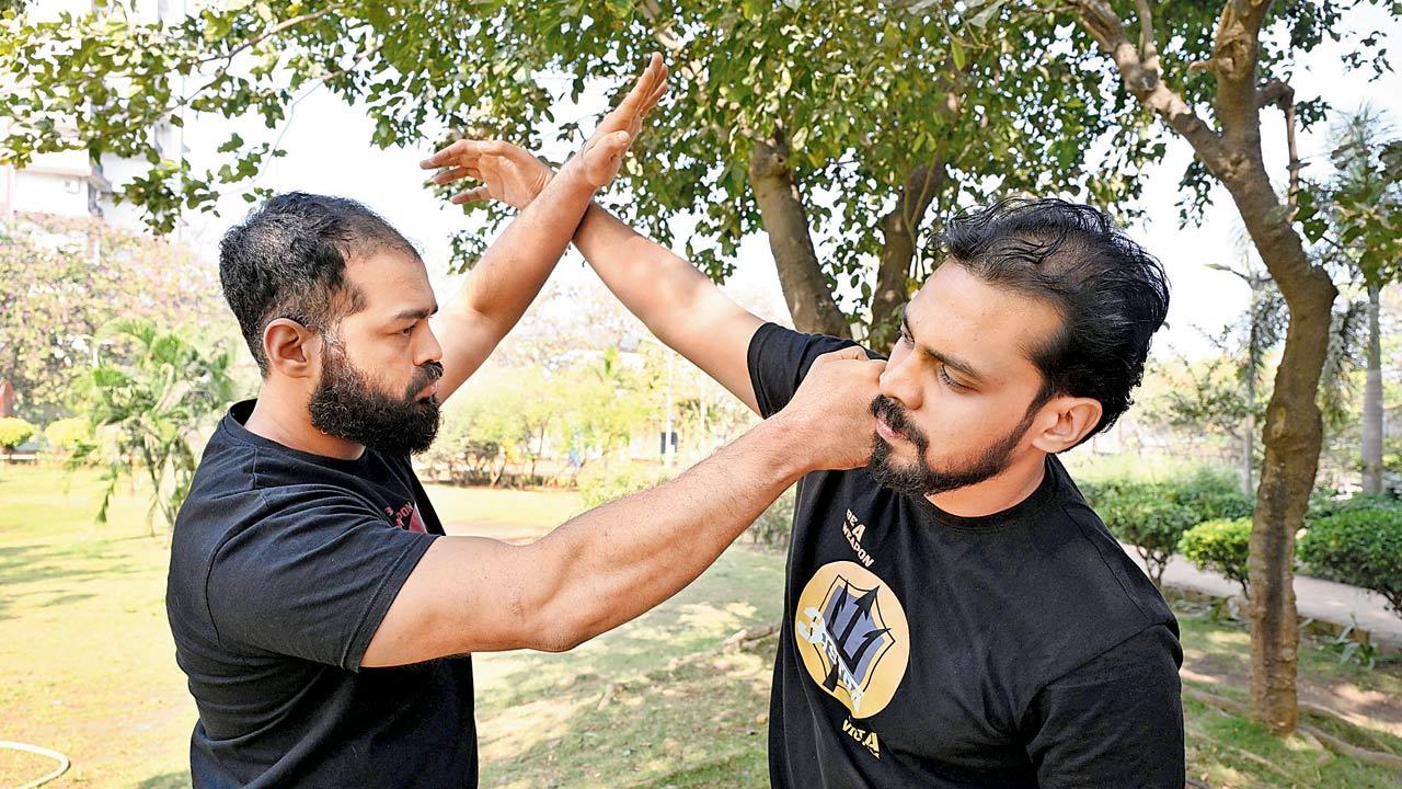 Anurag Rane (L), a Krav Maga coach, demonstrates self-defense with student Abhilash Aravindakshan in Borivili West. Aravindakshan feels the difference in both personal life and work since he started learning Krav Maga. Pic/Anurag Ahire
