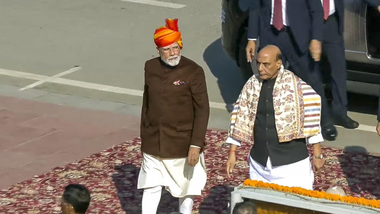 PM Modi wears yellow and red striped 'safa' with long veil, brown jacket