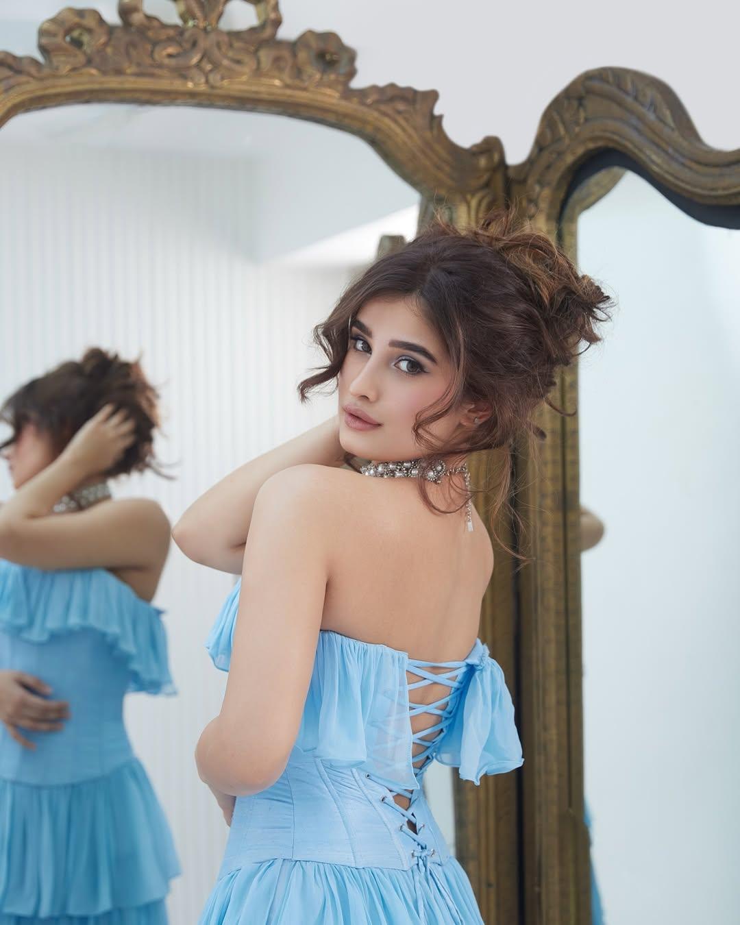 In this look, the actress stole our hearts in a blue backless outfit. The actress tied her hair in a messy bun and added a chic choker to enhance her appearance