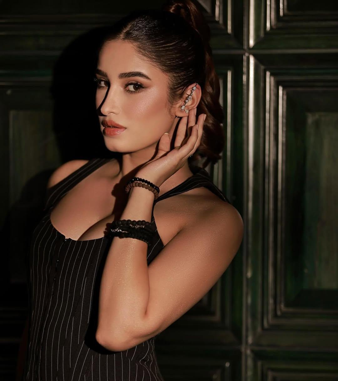 The bodycon outfit has a stylish back with lacework. The actress tied her hair in a stylish way and applied smokey eye makeup