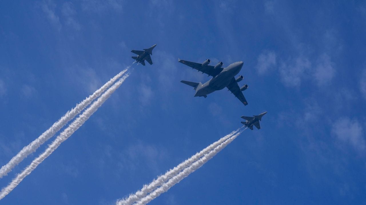 Indian Air Force's Su-30s aircrafts fly in a formation with a C-17 Globemaster during the rehearsals