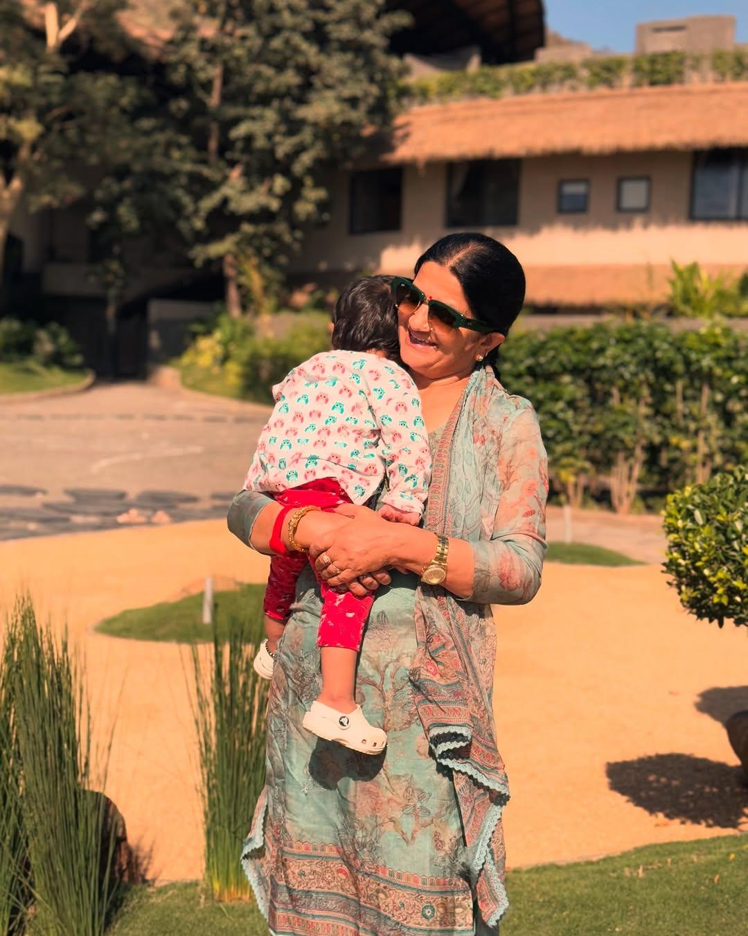 This picture has Rubina's mom posing for a happy picture with her granddaughter