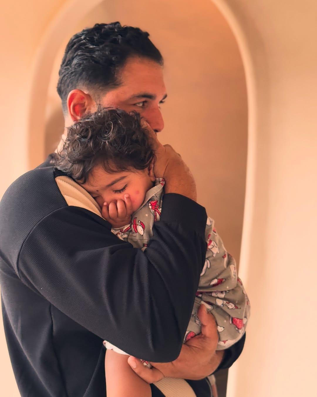 This picture has Abhinav Shukla holding their daughter in his arms as the baby angel sleeps peacefully