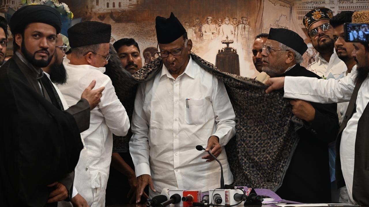 The maulanas and ulamas at the YB Chavan center draped Sharad Pawar in a shawl as a sign of respect