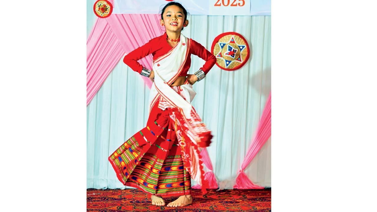 A girl performs Bihu dance on the stage during the event