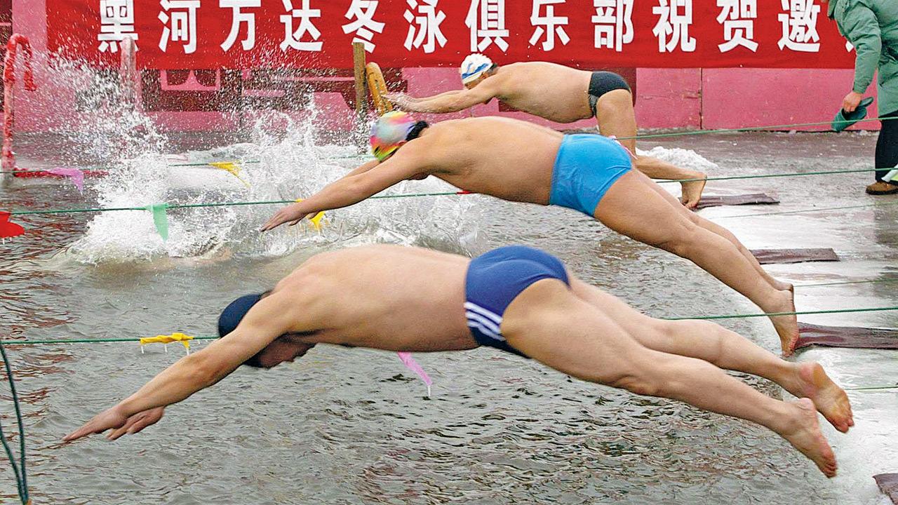 Swimmers are seen diving into freezing temperatures. PIC/GETTY IMAGES