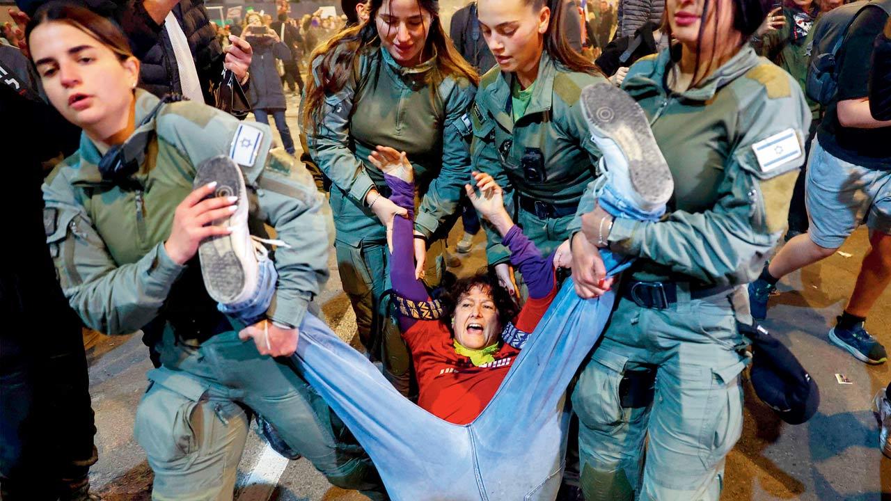 Israeli police remove a protester during a demonstration calling for the release of hostages in Gaza