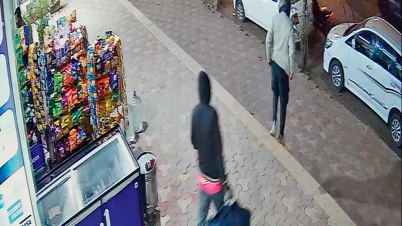 The burglars flee the jewellery store with their loot