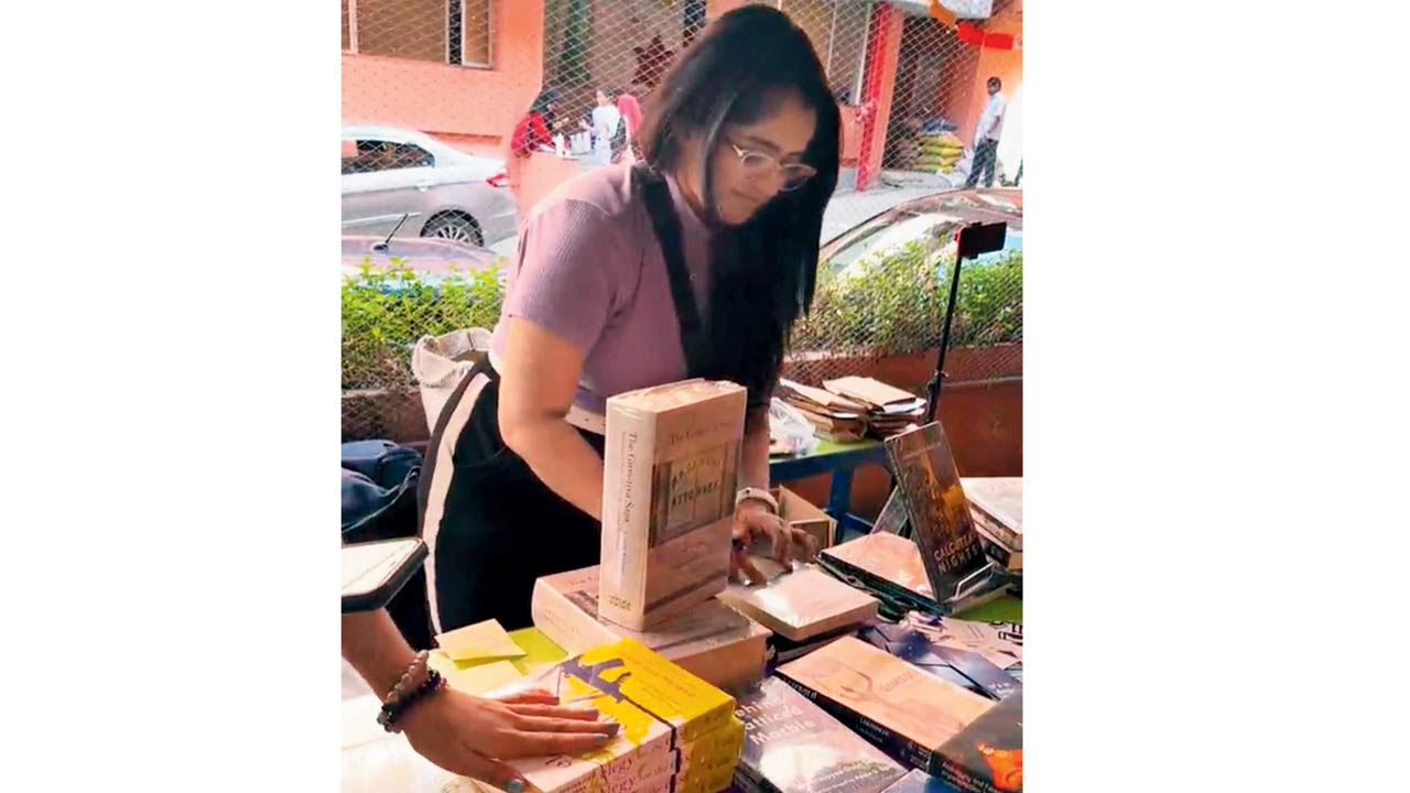 A girl browses books at a  previous edition of the fair