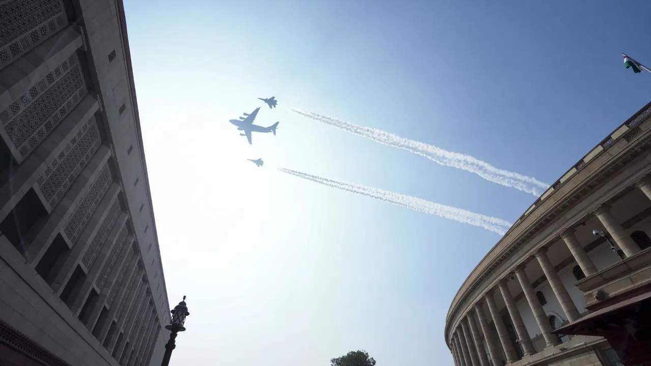 Indian Air Force's two Su-30 aircrafts with a C-17 Globemaster fly past the Samvidhan Sadan during the full dress rehearsal for the Republic Day Parade 2025