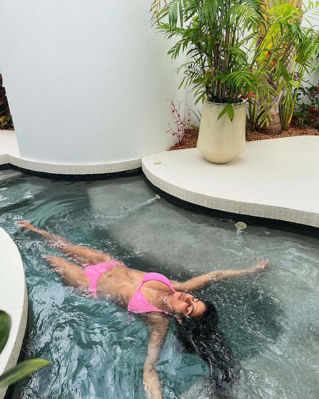 Priyanka Chopra relaxes in the pool wearing a pink bikini