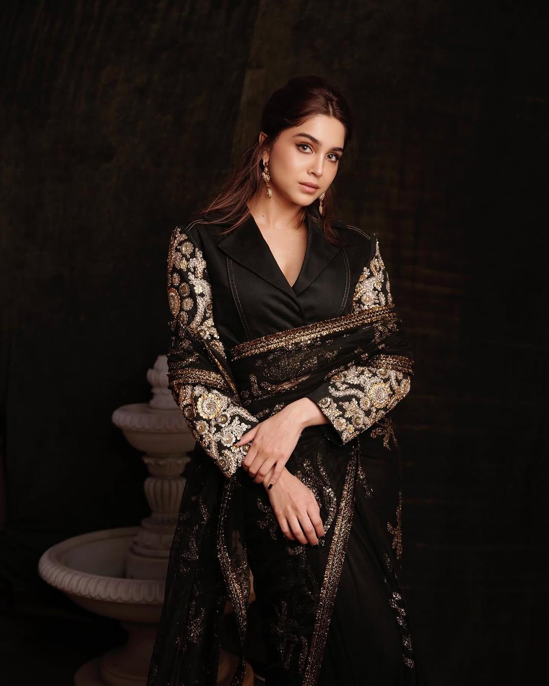 The look was further enhanced by a custom upcycled jacket that seamlessly blends black denim with archival gold embroidery. This unique piece was styled with a saree from Sabyasachi’s current collection, creating a striking fusion of black denim and intricately embroidered tulle