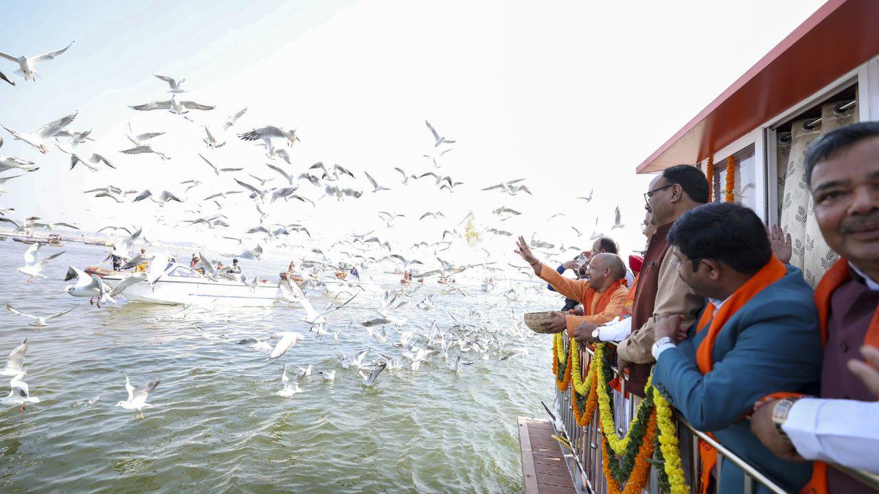 Before taking the holy dip, Yogi and cabinet members fed migratory birds