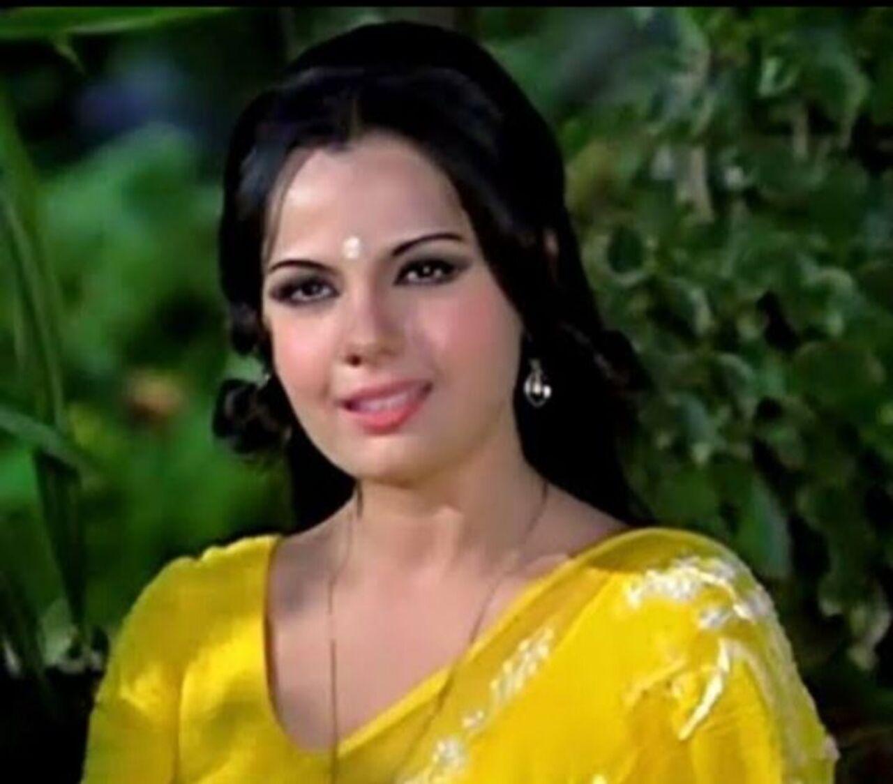 A white bindi is a risky choice, but Mumtaz pulls it off with such ease as she glows in this yellow saree and almost no makeup look.