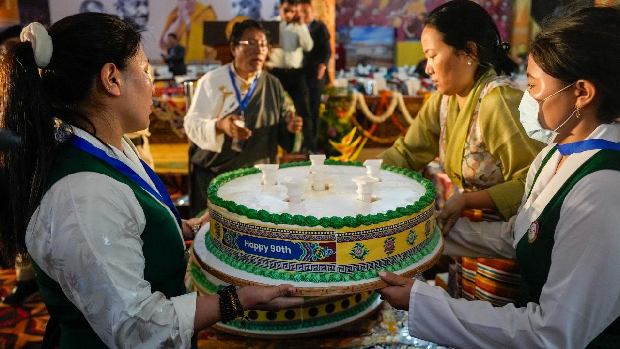 Members of Tibetan cultural groups also distributed cake on the occasion of the spiritual leader’s 90th birthday