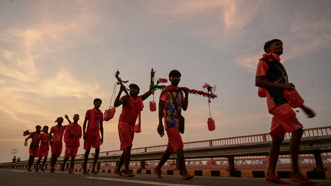 Lord Shiva devotees carry holy water of the Ganga River as they walk towards Varanasi to perform ‘Jalabhishek’ at Kashi Vishwanath Temple.