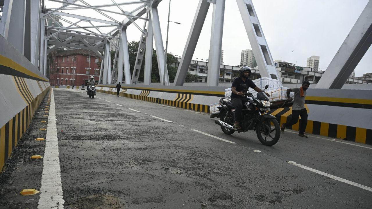 Commuters navigate cautiously over uneven surfaces on the eastern corridor of the Sindoor Flyover.