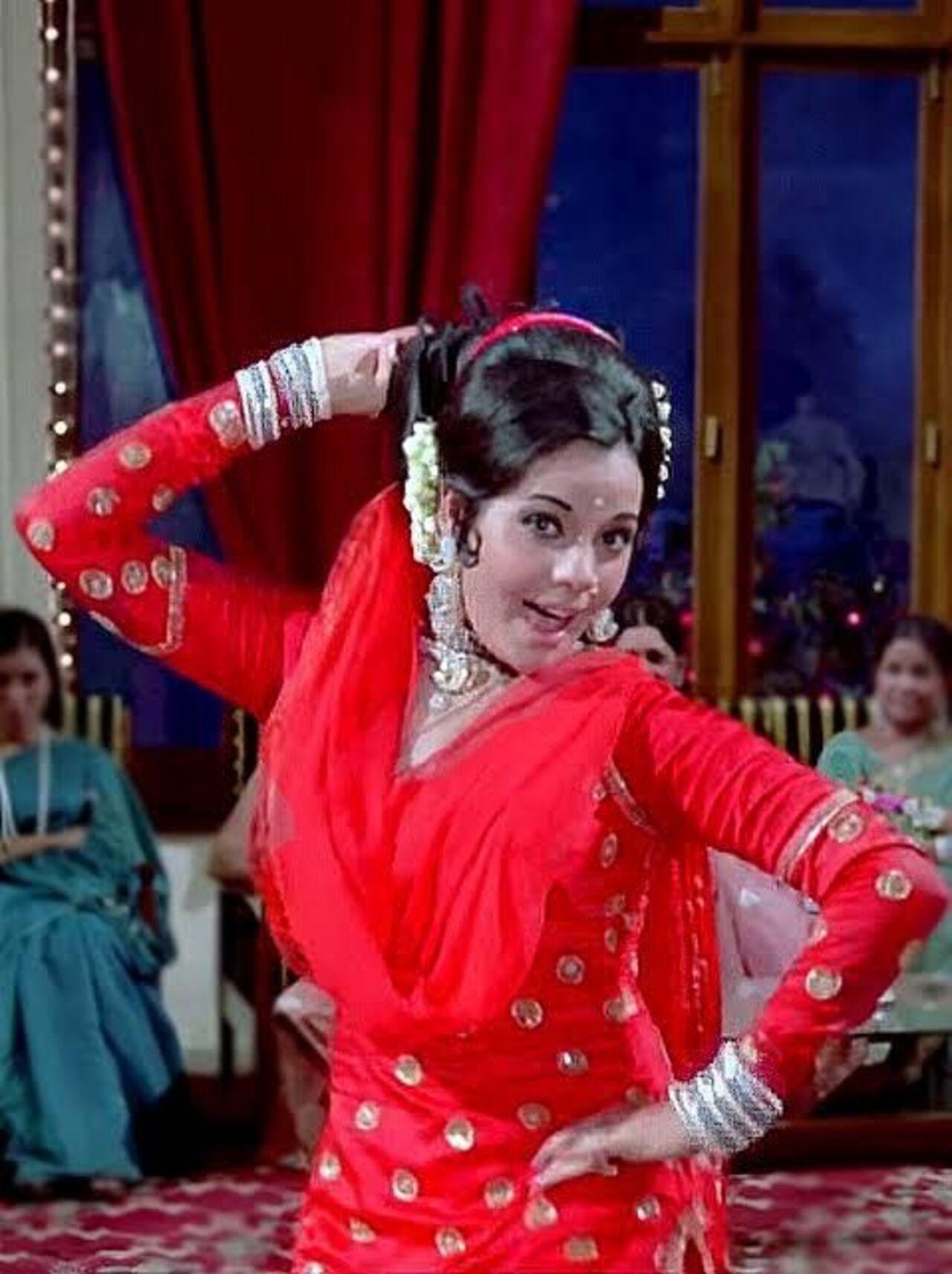 Radiating in red, Mumtaz steals the spotlight in this red Indian salwar suit with the dupatta covering her bun. Traditional, yet chic.
