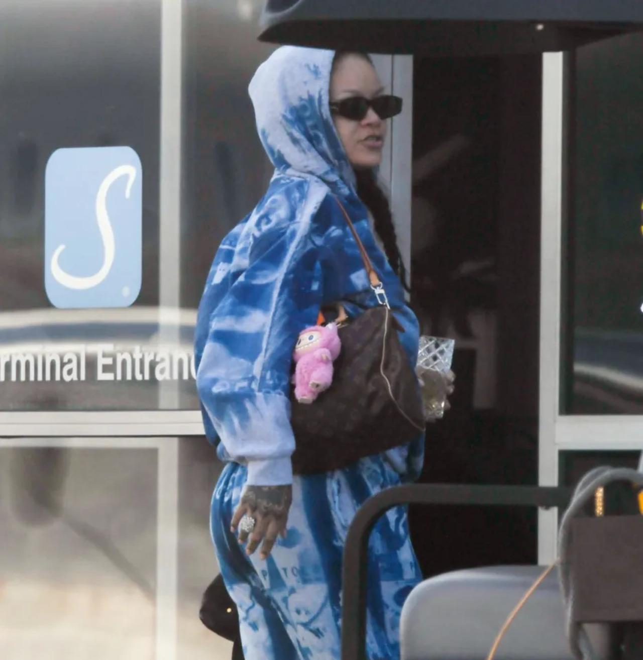 During one of her appearances at the airport, Rihanna hopped onto the labubu trend dressed in a blue hoodie, with a pink Labubu doll keychain attached to her handbag.
