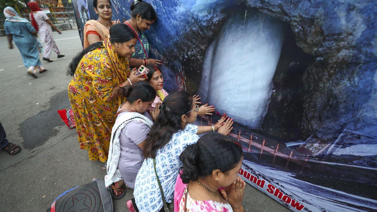 Pilgrims in Jammu were seen offering prayers to a poster of the Amarnath shrine as they continued their journey