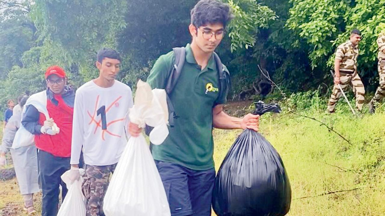 Ayaan Sham (in green) joins volunteers during the clean-up drive at Vihar lake. Pic Courtesy/Ayaan Sham