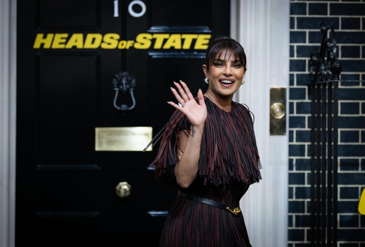 Priyanka Chopra as Noel Bisset in Heads of State
Priyanka Chopra Jonas flashes a graceful wave to the cameras, echoing the cool confidence of her role in Heads of State, where she plays a sharp, no-nonsense operative caught in the middle of global political mayhem