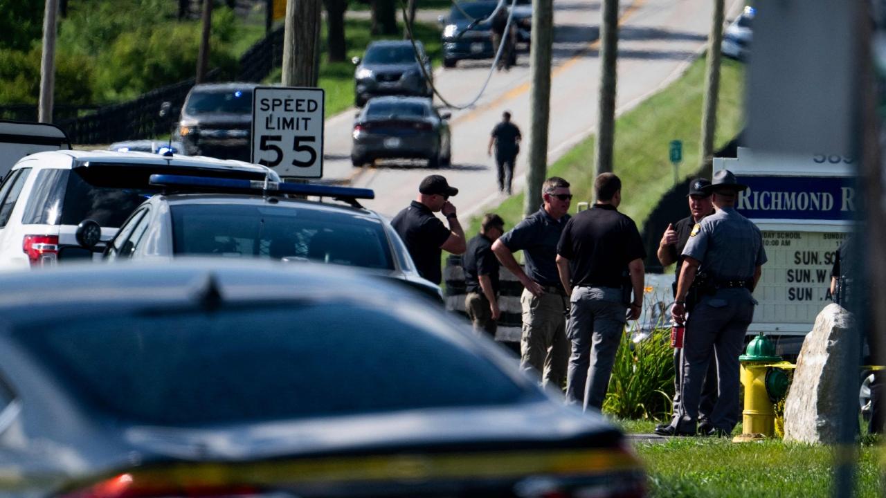 While addressing a news conference on Sunday, Lexington Police Chief Lawrence Weathers said the officer was shot before the suspect fled from the spot and carjacked a vehicle and reached Richmond Road Baptist Church about 15 miles away