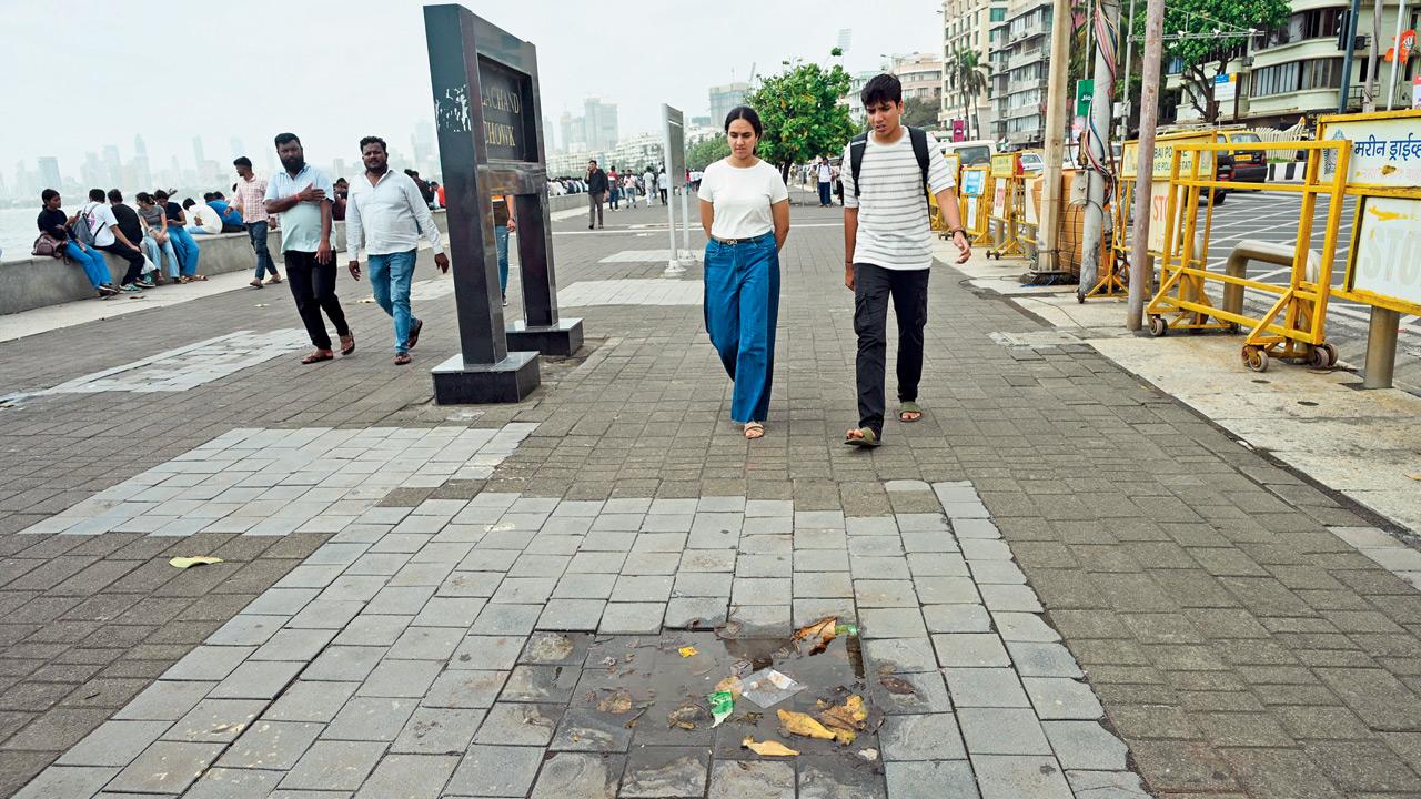 Another stretch of the Marine Drive promenade with sunken tiles and waterlogged patches