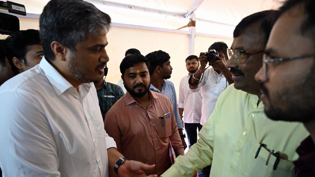 Nationalist Congress Party MLA Rohit Pawar and BJP Leader Sudhir Mungantiwar interact at Vidhan Bhavan, Mumbai