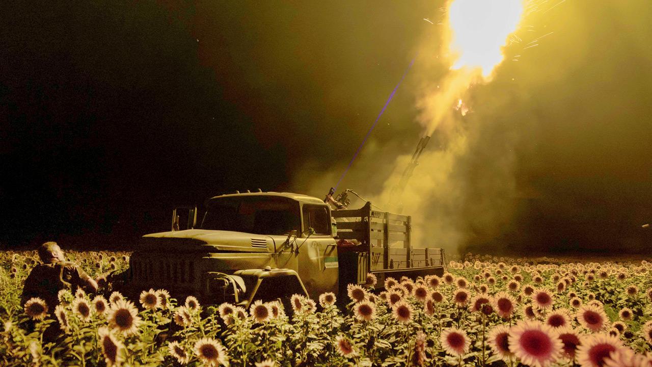 Ukrainian servicemen fire at a drone from a sunflower field