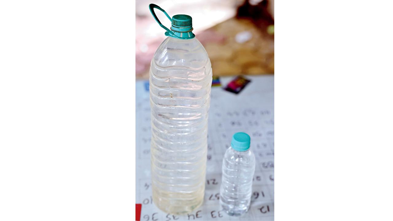 The dirty water residents have been receiving, displayed in a plastic bottle. Pics/Shadab Khan