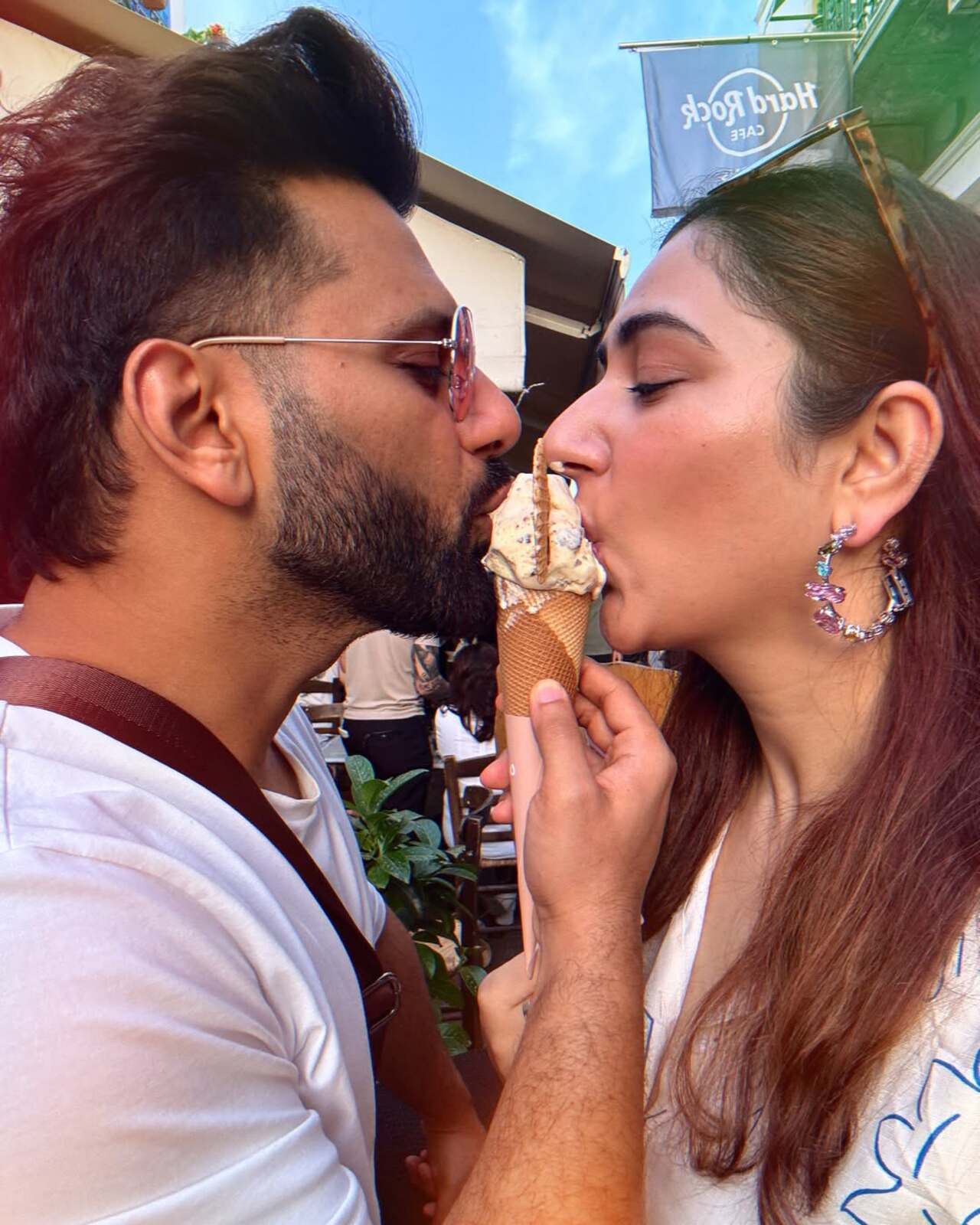 Not only life partners, but Rahul and Disha are also travel buddies and they never miss a moment to capture their romance. In this pic, they share a goofy yet romantic moment of eating ice cream and also kissing each other.