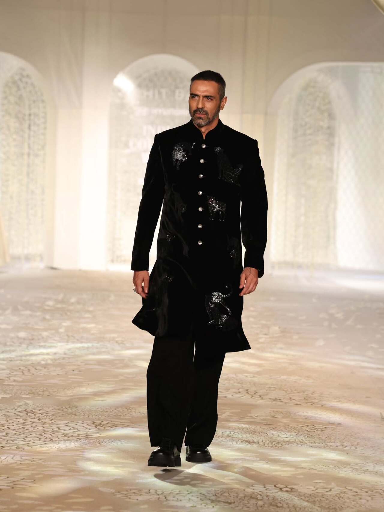 Arjun Rampal turned showstopper for Rohit Bal at the India Couture Week 2025 on 28th July in a black sherwani kurta with embellished details and a black salwar pant. 