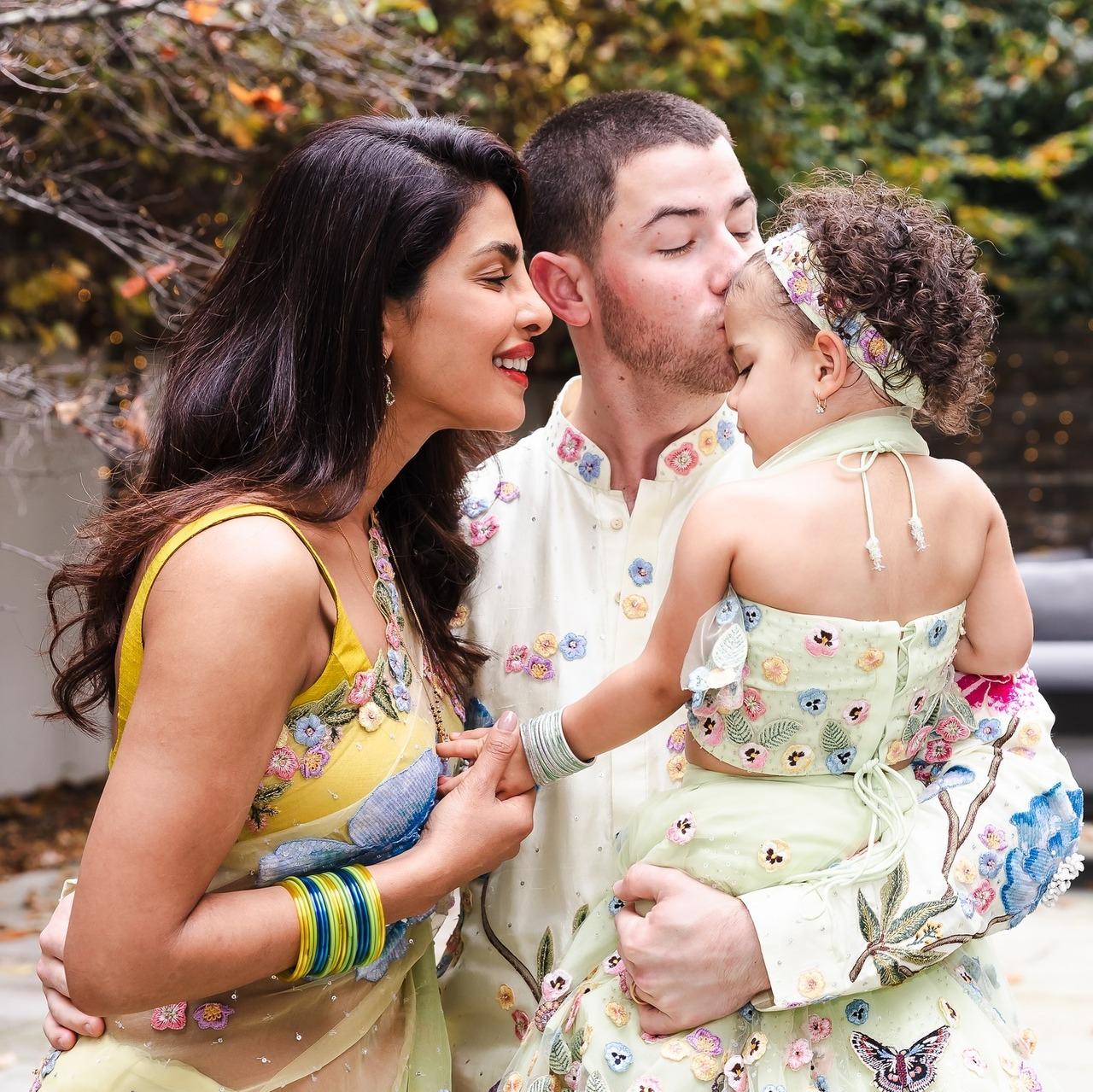 This family picture of the Jonas family is just too wholesome. Everything about this picture is just perfect - from Malti leaning on Nick while still holding Priyanka's hand, Nick affectionately kissing his daughter, forehead, and Priyanka interacting with the little one!